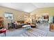 Bright living room featuring a sofa, armchairs, vaulted ceiling, and seamless flow to the kitchen at 6292 Kilmer Loop # 201, Golden, CO 80403
