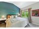 Serene main bedroom with accent wall, a large window, and neutral tones at 6292 Kilmer Loop # 201, Golden, CO 80403