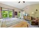 Bright primary bedroom with vaulted ceiling, balcony access, and dresser at 6292 Kilmer Loop # 201, Golden, CO 80403