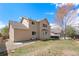 The home is set on a grassy lot with a patio, ready for entertaining and leisure at 10933 E 115Th Pl, Commerce City, CO 80640