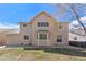 Rear exterior of the house showcasing a charming covered patio and a well-manicured lawn at 10933 E 115Th Pl, Commerce City, CO 80640