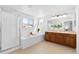 Bright bathroom with double vanity, soaking tub, and separate shower for a luxurious and relaxing experience at 10933 E 115Th Pl, Commerce City, CO 80640