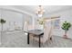Elegant dining room with stylish chandelier, neutral walls, and open layout to the living area at 10933 E 115Th Pl, Commerce City, CO 80640