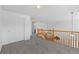 Open hallway with wooden railing, connecting various spaces with a blend of style and functionality at 10933 E 115Th Pl, Commerce City, CO 80640