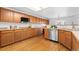 Spacious kitchen with hardwood floors, wood cabinets, stainless steel appliances, and ample counter space at 10933 E 115Th Pl, Commerce City, CO 80640