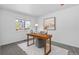 Cozy office space featuring a wooden desk with outside view and neutral decor for a tranquil and productive workspace at 10933 E 115Th Pl, Commerce City, CO 80640