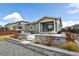Professionally landscaped backyard with a fire pit and covered porch, perfect for entertaining at 1925 Peregrine Dr, Brighton, CO 80601
