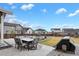 Spacious backyard with a dining set, built in barbeque, and pristine landscaping at 1925 Peregrine Dr, Brighton, CO 80601