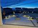 Backyard features outdoor fire pit and landscaping, beautifully lit for evening enjoyment at 1925 Peregrine Dr, Brighton, CO 80601