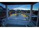 Backyard with gas firepit and beautifully designed landscaping, professionally lit at night at 1925 Peregrine Dr, Brighton, CO 80601