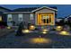 Backyard features landscaping, stone patios, and stone walkway, with outdoor lighting throughout at 1925 Peregrine Dr, Brighton, CO 80601