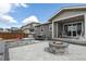 Backyard featuring a fire pit, patio set, and covered porch at 1925 Peregrine Dr, Brighton, CO 80601