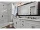 Elegant bathroom featuring a double vanity with marble countertops and a glass-enclosed shower at 1925 Peregrine Dr, Brighton, CO 80601