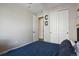 Bedroom with sliding closet doors, gray walls, and blue bed spread at 1925 Peregrine Dr, Brighton, CO 80601