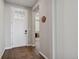 Bright foyer with a patterned rug on wood floors leading into a well-lit home at 1925 Peregrine Dr, Brighton, CO 80601