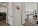 Hallway with hardwood floors leading to laundry room and the open living area at 1925 Peregrine Dr, Brighton, CO 80601