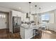 Bright kitchen with stainless steel appliances, a granite island, and pendant lighting at 1925 Peregrine Dr, Brighton, CO 80601