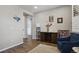 Inviting living room with a dark wood cabinet, and blue arm chair at 1925 Peregrine Dr, Brighton, CO 80601