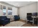 Bright office with two blue chairs, and a desk with two monitors at 1925 Peregrine Dr, Brighton, CO 80601