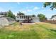 Expansive backyard with a shed, green lawn, and a charming screened-in porch at 6994 W Hinsdale Dr, Littleton, CO 80128