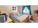 Comfortable bedroom with a cozy bed, natural wood furniture, and bright blue curtains at 6994 W Hinsdale Dr, Littleton, CO 80128
