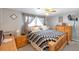 Comfortable bedroom featuring a wooden bed frame and soft, patterned comforter at 6994 W Hinsdale Dr, Littleton, CO 80128