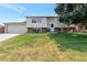 Charming two-story home with a well-maintained lawn and traditional architectural details on a sunny day at 6994 W Hinsdale Dr, Littleton, CO 80128