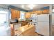 Functional kitchen with wooden cabinets, ample counter space, and modern appliances, offering a practical cooking environment at 6994 W Hinsdale Dr, Littleton, CO 80128