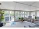 Bright sunroom with panoramic windows, tile flooring, comfortable seating, and indoor plants at 6994 W Hinsdale Dr, Littleton, CO 80128