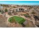 Expansive estate featuring a private putting green, lush landscaping, and a sprawling custom home at 4691 Bandera Pl, Parker, CO 80134