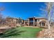Expansive backyard showcasing a lush lawn and a private patio with a charming home exterior at 4691 Bandera Pl, Parker, CO 80134