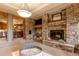 Large basement rec room with stone fireplace and wet bar at 4691 Bandera Pl, Parker, CO 80134