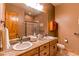 Bathroom with double sink vanity, granite counters, and a tiled walk-in shower at 4691 Bandera Pl, Parker, CO 80134