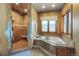 Bright bathroom featuring a walk-in shower and corner soaking tub with mosaic tile accents at 4691 Bandera Pl, Parker, CO 80134