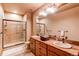 Spa-like bathroom with double vanity and a large shower at 4691 Bandera Pl, Parker, CO 80134