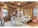 Cozy bedroom with crib and window seats at 4691 Bandera Pl, Parker, CO 80134