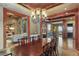 Dining room featuring beautiful millwork, chandelier and access to the rest of the home at 4691 Bandera Pl, Parker, CO 80134
