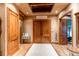 Elegant foyer with double doors, light wood floors, and a decorative ceiling feature at 4691 Bandera Pl, Parker, CO 80134
