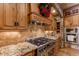 Gas range and custom cabinetry in a spacious kitchen at 4691 Bandera Pl, Parker, CO 80134