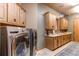 Large laundry room with ample cabinetry and modern appliances at 4691 Bandera Pl, Parker, CO 80134