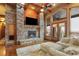 Spacious living room with a stone fireplace and hardwood floors at 4691 Bandera Pl, Parker, CO 80134