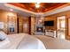 Main bedroom features fireplace, large TV, and ensuite bath at 4691 Bandera Pl, Parker, CO 80134