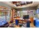 Executive office with coffered ceilings, built-in bookshelves, and large windows providing great natural light at 4691 Bandera Pl, Parker, CO 80134