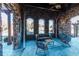 Cozy outdoor seating area with stone walls and a comfortable sofa for relaxation at 4691 Bandera Pl, Parker, CO 80134