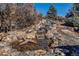Beautiful multi-tiered waterfall and pond with natural stone surroundings, creating a serene outdoor oasis at 4691 Bandera Pl, Parker, CO 80134