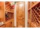 Custom wine cellar with wooden racks and storage at 4691 Bandera Pl, Parker, CO 80134