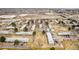 Wide aerial shot of a community showcasing multiple townhomes, parking, and a nearby commercial area at 5721 W 92Nd Ave # 53, Westminster, CO 80031