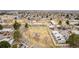 Bright aerial view of townhomes with solar panels, open green space, and community playground at 5721 W 92Nd Ave # 53, Westminster, CO 80031