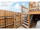 Backyard entrance with a wooden fence and stairs leading to the deck for outdoor access at 5721 W 92Nd Ave # 53, Westminster, CO 80031