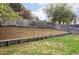 Large backyard features tiered garden beds and wooden fence at 9380 Raleigh Ct, Westminster, CO 80031